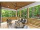 Relaxing covered patio features comfortable seating, a wood ceiling, and serene view of the surrounding woods at 160 Cedarwood Ln, Roswell, GA 30075