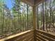 View from the porch into the verdant forest canopy, which creates a sense of privacy at 160 Cedarwood Ln, Roswell, GA 30075