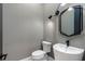 Stylish powder room with modern vanity and geometric mirror at 160 Cedarwood Ln, Roswell, GA 30075