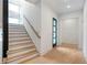 Modern staircase with light wood steps and dark wood railing at 160 Cedarwood Ln, Roswell, GA 30075