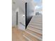 Modern staircase with light wood and a dark accent wall at 160 Cedarwood Ln, Roswell, GA 30075