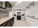 Basement laundry room with modern washer and dryer, ample cabinetry, and storage at 2148 Allgood Rd, Marietta, GA 30062