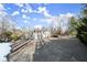 Gravel driveway with ample parking and wooded backdrop at 2148 Allgood Rd, Marietta, GA 30062