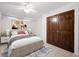 Bright bedroom with ceiling fan and double doors to closet at 272 14Th St # 23, Atlanta, GA 30309