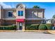 Townhouse exterior featuring a red awning and manicured landscaping at 3301 Henderson Mill Rd, Atlanta, GA 30341