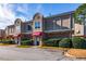 Three-unit townhouse building with brick and neutral siding at 3301 Henderson Mill Rd, Atlanta, GA 30341