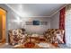 Living room with two floral couches, coffee table, and wall-mounted TV at 3301 Henderson Mill Rd, Atlanta, GA 30341