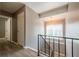 Light-filled stairwell with wood-look flooring and neutral walls at 3301 Henderson Mill Rd, Atlanta, GA 30341