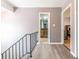 Upstairs hallway with wood-look flooring and access to bedrooms and bathroom at 3301 Henderson Mill Rd, Atlanta, GA 30341