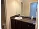 Bathroom with dark vanity and a white sink at 606 Grenier Ter, Lawrenceville, GA 30045