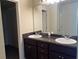 Bathroom with double vanity, granite countertop, and large mirror at 606 Grenier Ter, Lawrenceville, GA 30045