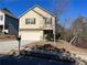 Two-story house with beige siding, attached garage, and manicured lawn at 606 Grenier Ter, Lawrenceville, GA 30045