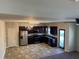 Modern kitchen with stainless steel appliances and dark wood cabinets at 606 Grenier Ter, Lawrenceville, GA 30045