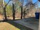 Concrete patio overlooks a wooded area, offering a peaceful view at 606 Grenier Ter, Lawrenceville, GA 30045