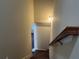 Carpeted staircase with wooden handrail leading upstairs at 606 Grenier Ter, Lawrenceville, GA 30045