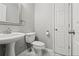 Clean bathroom with pedestal sink, toilet and marble flooring at 705 Pecan Knoll Dr, Marietta, GA 30008