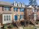 Brick front townhouse with a charming blue door and landscaping at 705 Pecan Knoll Dr, Marietta, GA 30008