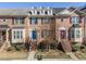 Brick front townhouse with three-story elevation, steps, and landscaping at 705 Pecan Knoll Dr, Marietta, GA 30008