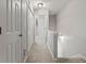 Bright hallway with carpet, leading to bedrooms and stairs at 705 Pecan Knoll Dr, Marietta, GA 30008