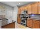 Kitchen with granite countertops, stainless steel appliances, and wood cabinets at 705 Pecan Knoll Dr, Marietta, GA 30008