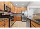 Kitchen with granite countertops, stainless steel appliances, and wood cabinets at 705 Pecan Knoll Dr, Marietta, GA 30008