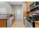 Kitchen with granite countertops, stainless steel appliances, and wood cabinets at 705 Pecan Knoll Dr, Marietta, GA 30008