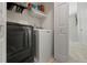 Convenient laundry room with washer, dryer, and ample shelving at 705 Pecan Knoll Dr, Marietta, GA 30008