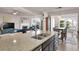 Large kitchen island with granite countertops and a double sink, perfect for food prep at 6825 Ashford Manor Way, Cumming, GA 30040