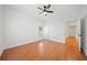 Well lit bedroom with hardwood floors, ceiling fan and access to hallway at 520 Mary Sw St, Atlanta, GA 30310