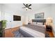 Main bedroom with hardwood floors, ceiling fan, and gray bedding at 520 Mary Sw St, Atlanta, GA 30310