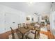 Open concept dining area with hardwood floors and rustic farmhouse table at 520 Mary Sw St, Atlanta, GA 30310