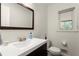 Half bathroom featuring a modern vanity and a well-lit mirror at 3616 Longfellow Trl, Marietta, GA 30062