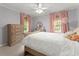 Bedroom featuring gray walls, pink curtains, and plush decorations at 3616 Longfellow Trl, Marietta, GA 30062