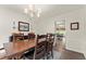 Spacious dining room with hardwood floors, a large wooden table, and elegant chandelier at 3616 Longfellow Trl, Marietta, GA 30062