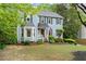 Charming two-story home with a well-manicured lawn, garden beds and walkway leading to the front door at 3616 Longfellow Trl, Marietta, GA 30062