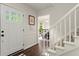 Bright foyer featuring hardwood floors, a staircase, and an open view into the dining room at 3616 Longfellow Trl, Marietta, GA 30062