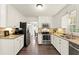 Modern kitchen with white cabinetry, stainless steel appliances, and hardwood floors at 3616 Longfellow Trl, Marietta, GA 30062