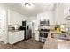 Bright kitchen with white cabinets, stainless steel appliances, granite counters, and hardwood floors at 3616 Longfellow Trl, Marietta, GA 30062