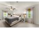 Spacious main bedroom with neutral colors, large windows, and cozy bedding at 3616 Longfellow Trl, Marietta, GA 30062