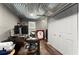 Finished office with modern desk, closet, and corrugated steel ceiling at 3616 Longfellow Trl, Marietta, GA 30062
