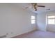 Bright bedroom with two windows, a ceiling fan, and neutral-toned walls and carpet at 3640 Longfellow Trl, Marietta, GA 30062