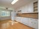 Traditional kitchen featuring white cabinets, laminate countertops and wood floors at 3640 Longfellow Trl, Marietta, GA 30062