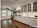 Bright kitchen with recessed lights, stainless steel appliances and white cabinets with glass fronts at 3640 Longfellow Trl, Marietta, GA 30062