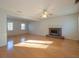 Spacious living room featuring hardwood floors, a classic brick fireplace, and bright windows for ample natural light at 3640 Longfellow Trl, Marietta, GA 30062
