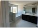 A bright bathroom features dual sink vanity, soaker tub, and glass door shower at 226 Depot Landing Rd # 56, Auburn, GA 30011