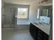A bathroom features dual sink vanity, soaking tub, and glass door shower at 226 Depot Landing Rd # 56, Auburn, GA 30011