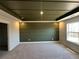 A bedroom features stylish, paneled wall and tray ceiling details with a window view at 226 Depot Landing Rd # 56, Auburn, GA 30011