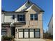 Charming brick and siding home featuring a two-car garage and well-maintained landscaping at 226 Depot Landing Rd # 56, Auburn, GA 30011