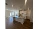 Open-concept kitchen boasts a large island, granite countertops, and modern pendant lighting at 226 Depot Landing Rd # 56, Auburn, GA 30011