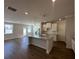 Open-concept kitchen boasts a large island, granite countertops, and modern pendant lighting at 226 Depot Landing Rd # 56, Auburn, GA 30011
